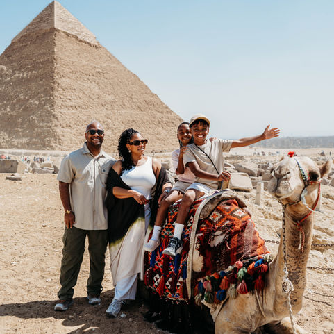 • Great Pyramid of Giza and Sphinx at the Giza Plateau.
• Traveler exploring the Pyramids of Giza in Cairo.
• Interior displays and artifacts at the Grand Egyptian Museum.
• Citadel of Cairo with view of the Mohamed Ali Mosque.
• Mohamed Ali Mosque architecture and interior details.
• Walking through Moez Street in Cairo’s historic district.
• Traditional shops and Islamic architecture along Moez Street.
• Sunrise hot air balloon flying over Luxor.
• Aerial view of Luxor’s farmlands and ancient sites from a balloon.
• Entrance to the Valley of the Kings in Luxor.
• Tomb artwork and details inside the Valley of the Kings.
• Front view of the Temple of Hatshepsut built into the cliffs.
• The Colossi of Memnon statues in Luxor.
• Rows of giant columns inside Karnak Temple.
• Hieroglyphs and architecture at Karnak Temple.
• Luxor Temple illuminated at dusk.
• Statues and columns at Luxor Temple at night.