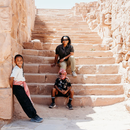 • Entrance to Petra through the Siq canyon in Jordan.
• Narrow sandstone walls of the Siq leading to Petra.
• First view of the Treasury at Petra.
• The Treasury monument carved into rock at Petra.
• Visitors standing in front of the Treasury in Petra.
• Long walking path inside the Petra archaeological site.
• Steps leading up to the Monastery in Petra.
• Children riding donkeys during the climb in Petra.
• Wide view of Petra’s rock formations and trails.
• The Monastery monument at the top of Petra.
• Family exploring Petra’s ancient pathways.
• Scenic overlook from the rear of Petra.
• Stone steps and cliffs along the Petra ascent route.
• Visitors resting during the climb to Petra’s Monastery.
• Expansive desert landscape surrounding Petra.