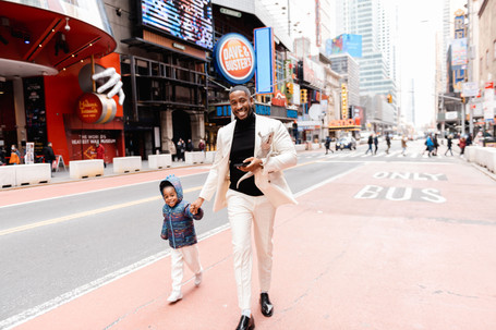 Keenan had meticulously arranged his proposal to Emilee, the love of his life, in the form of an unexpected surprise. In front of his family and close friends, Keenan popped the question to Emilee in the center of Times Square. "Will you be my wife?"