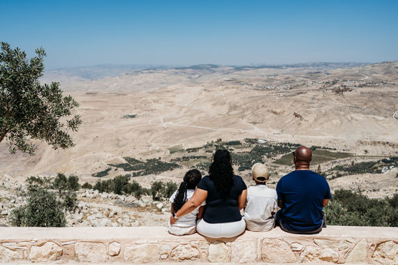 • The baptism site of Jesus is located at the Jordan River in Bethany Beyond the Jordan.
• Family visiting the baptism site of Jesus at the Jordan River.
• Church of St. John the Baptist near the Jordan River.
• View of the Jordan River surrounded by historic landmarks.
• Mount Nebo is a viewpoint overlooking the Jordan Valley.
• A family is standing at Mount Nebo, the location where Moses first saw the Promised Land.
• Landscape view from Mount Nebo toward Israel.
• Biblical site signage at Bethany Beyond the Jordan.
• Quiet moment at the Jordan River baptism site.
• Scenic overlook from Mount Nebo in Jordan.