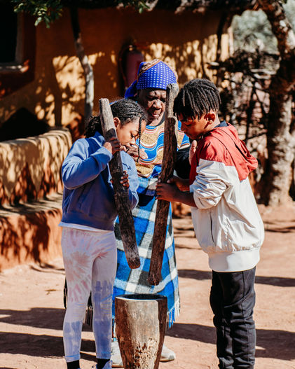Cultural Demonstrations & Learning:
• Traditional dance performance at Bahurutshe Cultural Village.
• Bahurutshe dancers performing in traditional attire.
• Cultural guide explaining Botswana marriage customs.
• Demonstration of traditional marriage confirmation practices.
• Visitors learning about Botswana’s village names and history.
Family Interaction & Animals:
• Children playing with animals at Bahurutshe Cultural Village.
• Kids interacting with goats and livestock in the cultural village.
• Family exploring the Bahurutshe community with animals nearby.
• Child petting a village animal during the cultural visit.
• Kids learning about traditional village life in Botswana.
Dance & Community:
• Guests joining a traditional Bahurutshe dance.
• Circle dance celebrating Botswana culture.
• Bahurutshe performers teaching visitors traditional movements.
• Family participating in a cultural dance experience.
• Community members performing in the outdoor dance area.
Village Setting:
• Entrance to the Bahurutshe Cultural Village.
• Traditional huts and cultural structures in Botswana.
• Outdoor cultural village landscape.
• Family photo with Bahurutshe dancers.
• Cultural artifacts displayed at the Bahurutshe Village.