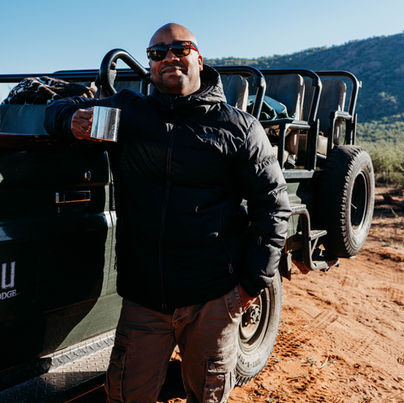 • Family on safari vehicle at Tau Game Lodge in Madikwe.
• Guide Silas is leading a game drive in the Madikwe Game Reserve.
• Wildlife sighting during safari at Madikwe, South Africa.
• Elephants gathering near the waterhole at Tau Game Lodge.
• Sunset view over Madikwe Game Reserve.
• Tau Game Lodge's exterior overlooks the landscape.
• A safari vehicle is driving through 76,000 acres of Madikwe terrain.
• Close-up of animals spotted during our safari.
• The family is enjoying a VIP safari experience in South Africa.
• The Madikwe landscape was captured during the sunrise game drive.