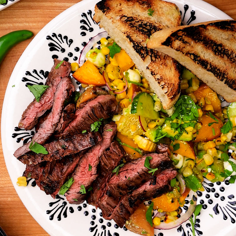 Citrus-marinated grilled skirt steak with charred peach salad