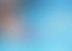 A child at the edge of the pool practicing swim kicks