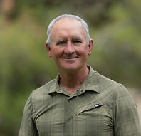 This is author WL Bach he is in his 30's and is wearing a green shirt.