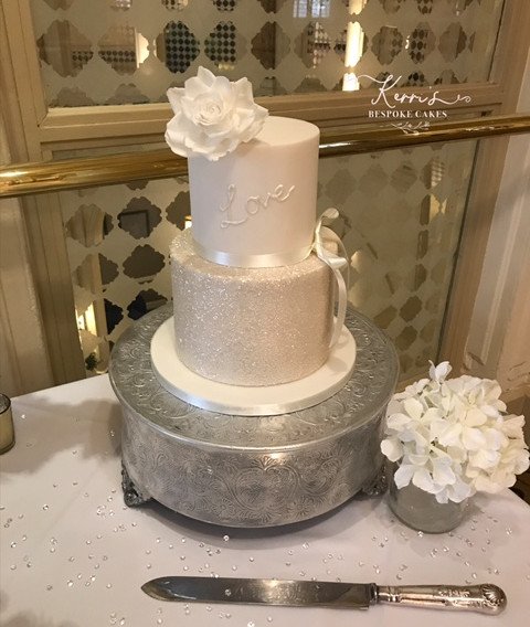 All white wedding cake with rose at Midl