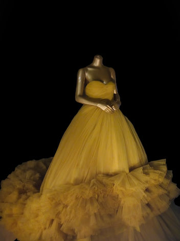 Fashion Museum Photoshoot of Yellow Giambattista Valli tulle dress on a mannequin with black background. Photographed at Kensington Palace.