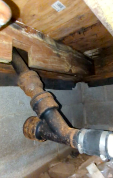 Notch at bottom of joist for cast iron drain pipe