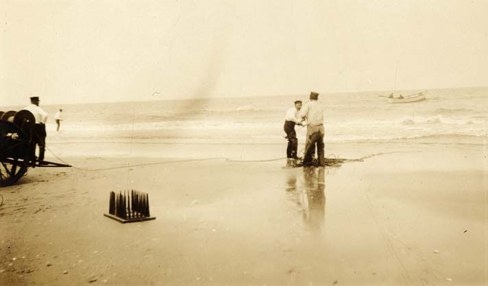 When wrecks were close enough to shore, Surfmen used a Lyle Gun to deploy a line to the ship to allow a breeches buoy to carry distressed mariners over the water to the beach, Undated, Charles Evans Collection, Outer Banks History Center, State Archives of North Carolina.