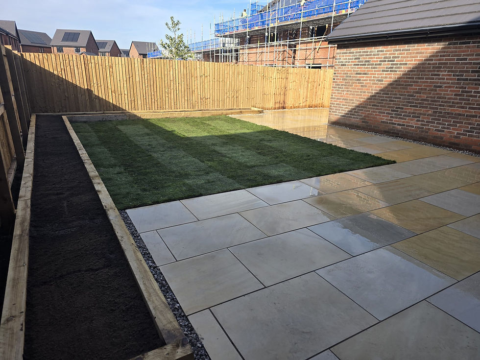 Finished landscaping project in Stockport with patio and lawn.