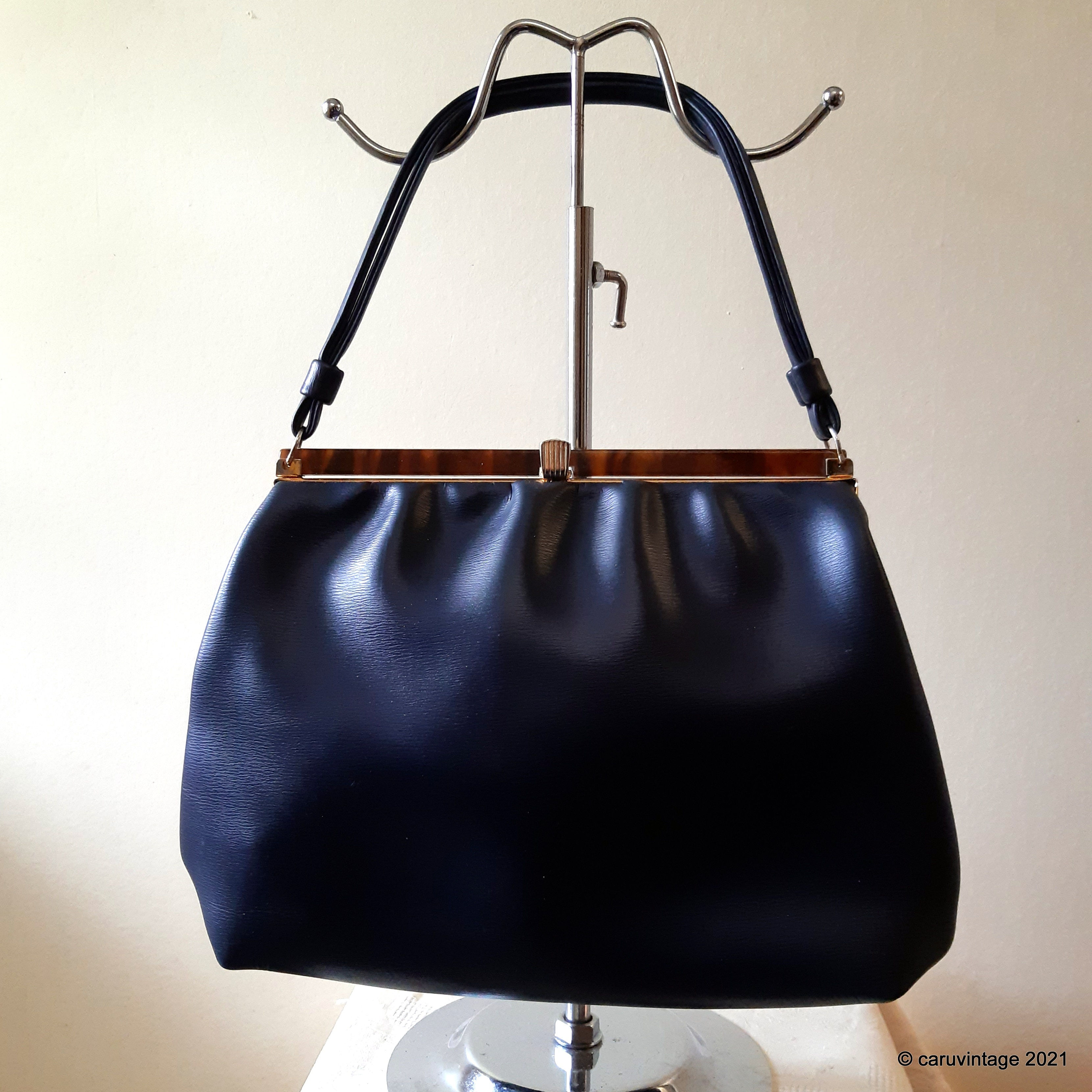 Navy blue soft vinyl handbag with tortoiseshell effect top
