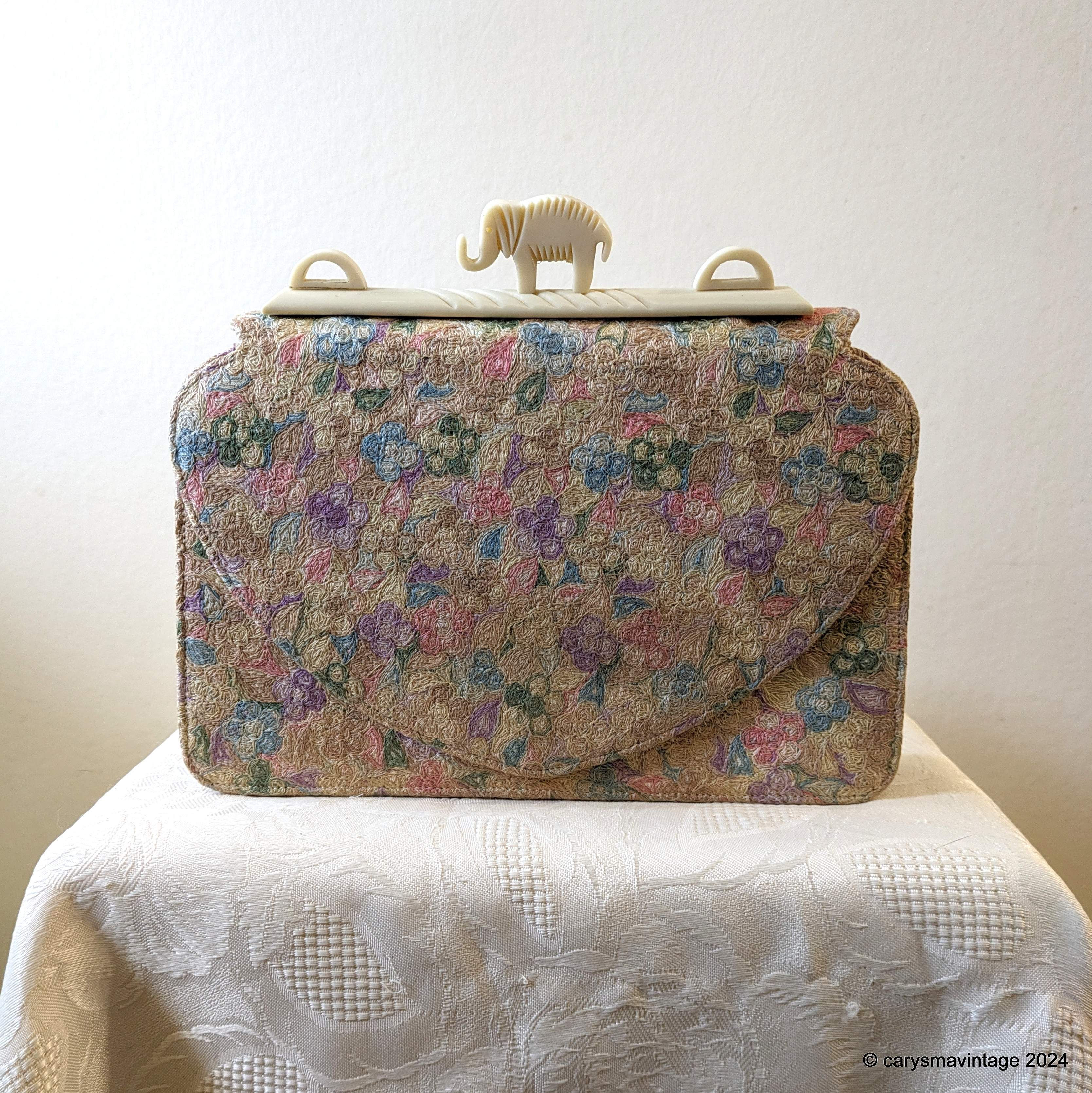 Embroidered clutch bag with celluloid elephant decoration