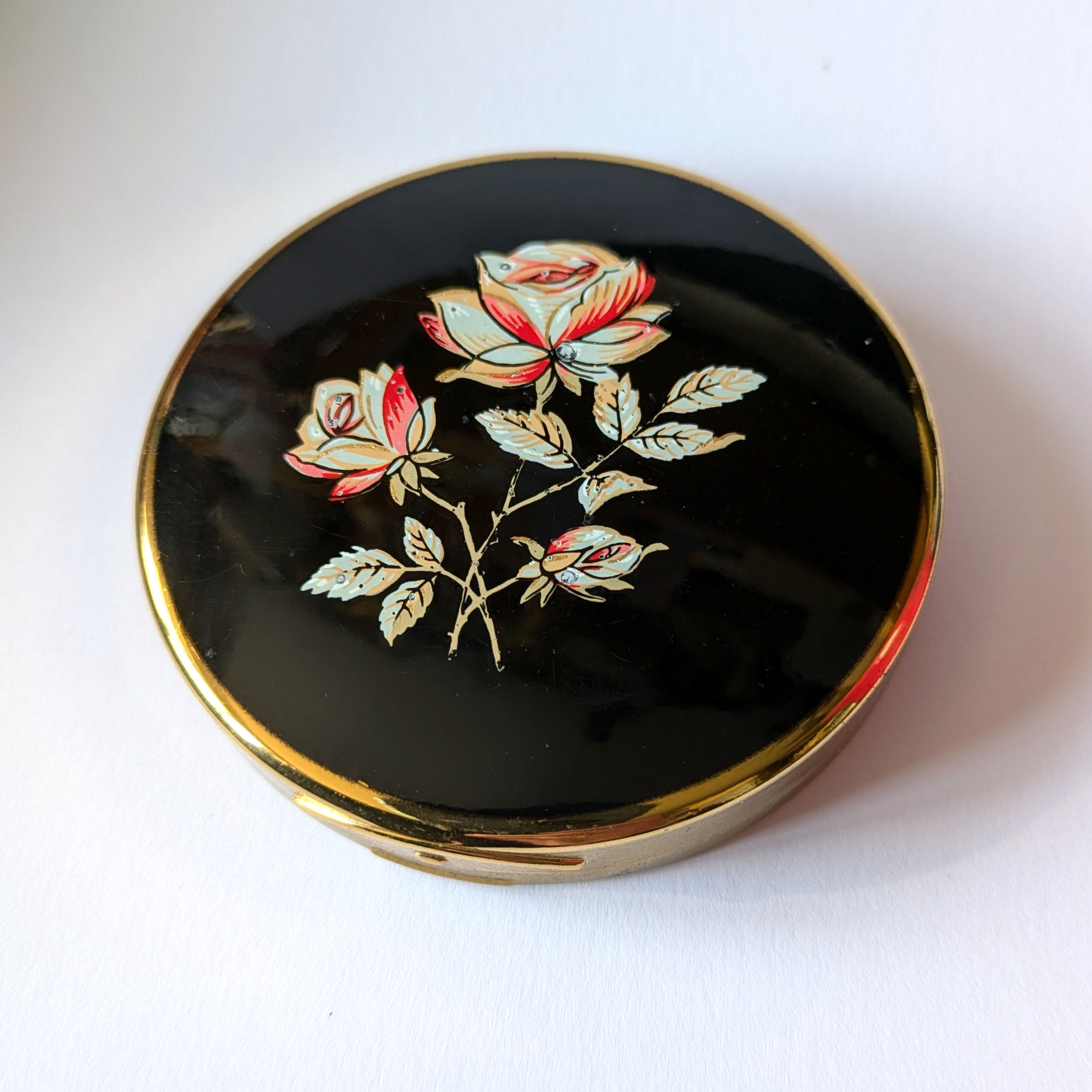 Black enamelled rose design powder compact