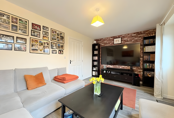 WJO Stays living room with sofa, coffee table and TV.