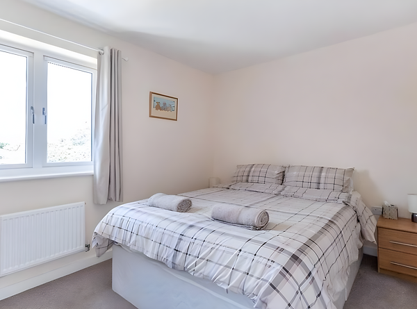 WJO Stays bedroom with a double bed and fresh towels.