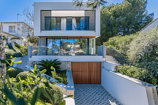 Modern white villa for Airbnb management with wood garage.