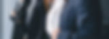 positive-diverse-coworkers-standing-near-window-
