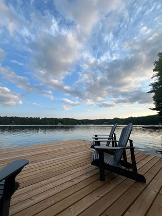 New dock on the water with Adirondack chairs