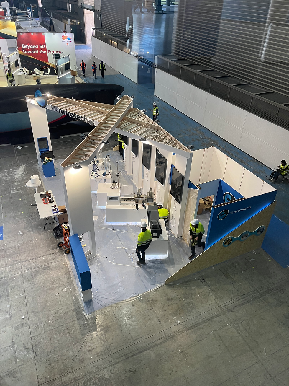 Aerial view of VEnvirotech booth during installation, with staff assembling the structure for the sustainability expo.