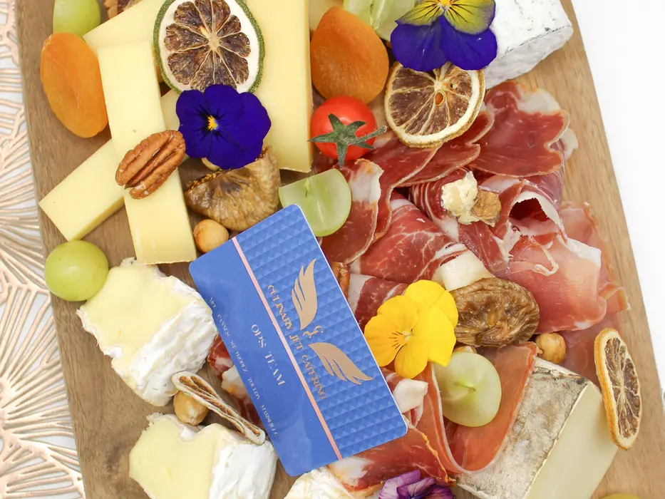 luxury private jet dining artisan cheese and charcuterie board with premium cheeses, cured meats, dried fruits, and edible flowers