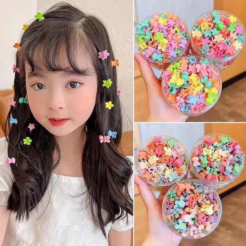 Thumbnail: Little girl with colorful hair clips holding star-shaped accessories. NanaPouchKids