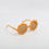 Thumbnail: Orange round sunglasses on white background. NanaPouchKids accessory product promotion.