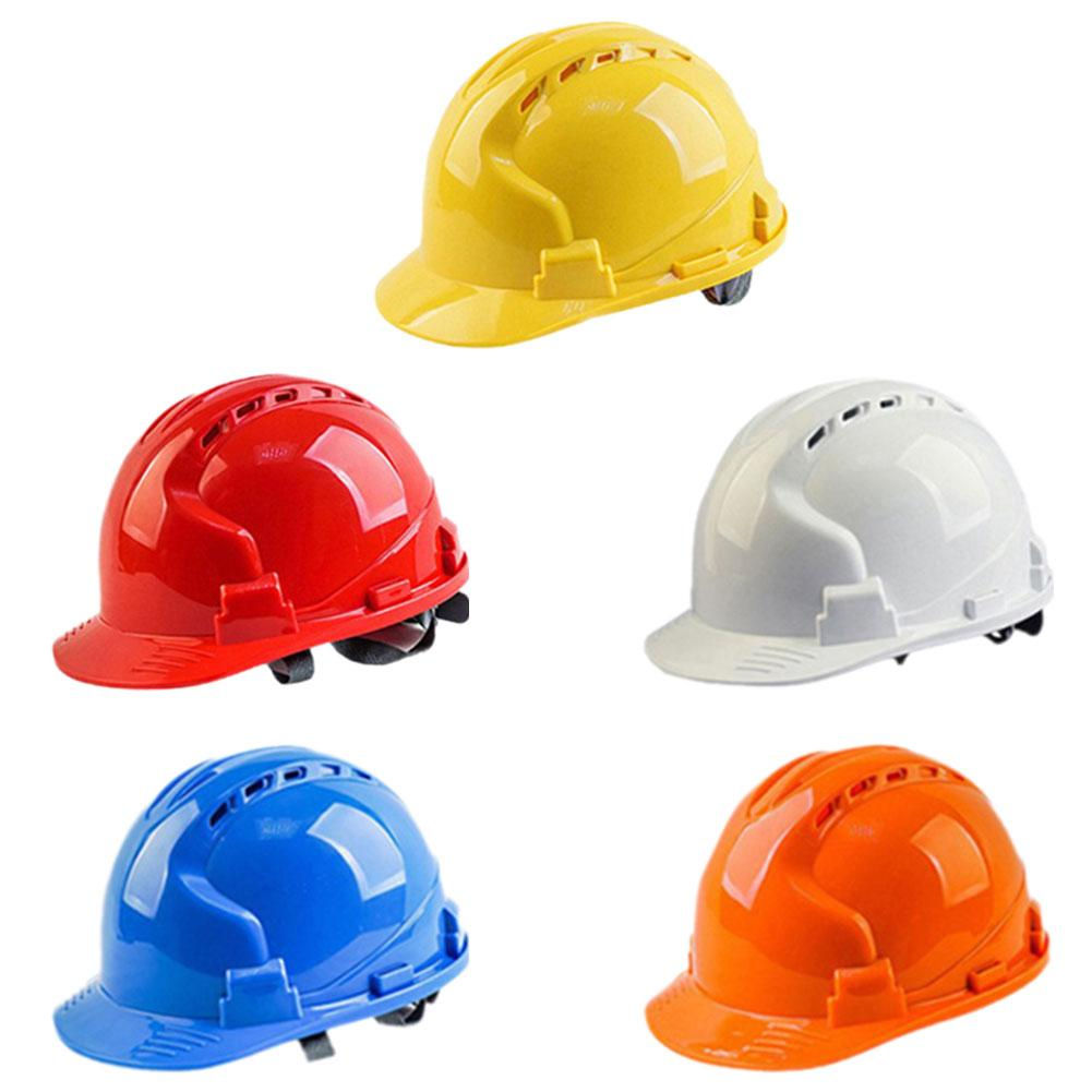 A collection of solid construction hard hats in various colors, designed for worker safety on construction sites.