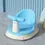 Thumbnail: Blue baby bath seat on the floor. NanaPouchKids