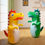 Thumbnail: Two dinosaur inflatable toys stand in a room, children's toys, NanaPouchKids