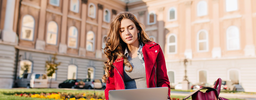 outdoor-portrait-serious-curly-female-student-sitting-with-laptop-ground.jpg