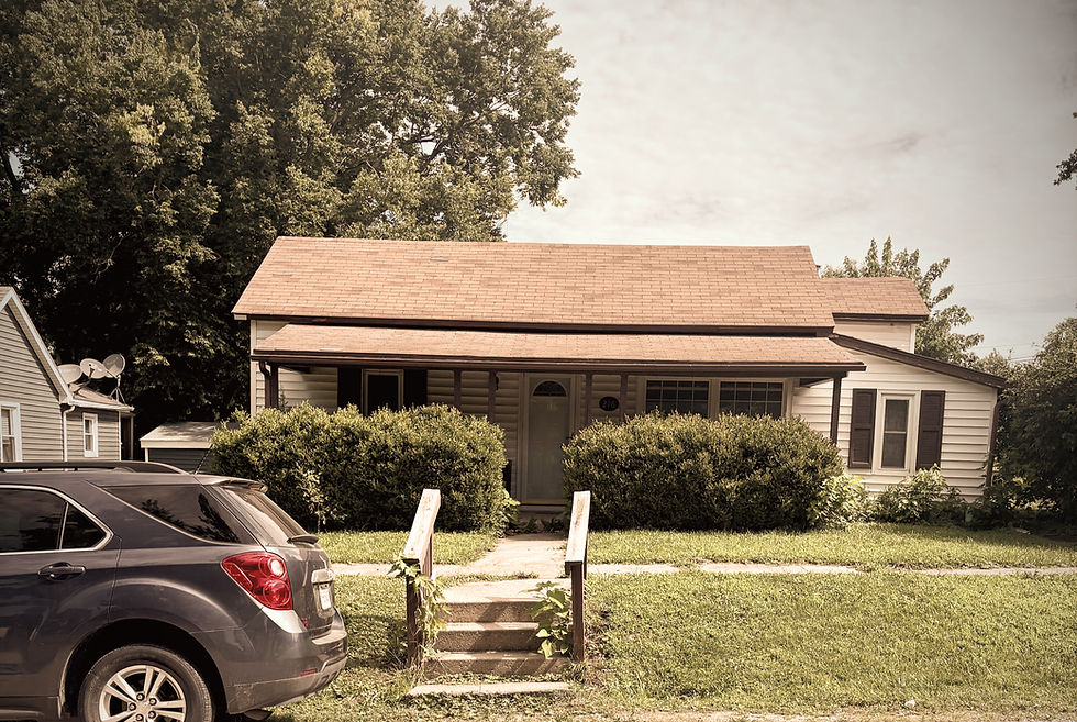 Home with deferred maintenance and over growth in front of home. Houston Zizza Keller Williams Platinum Partners 2026