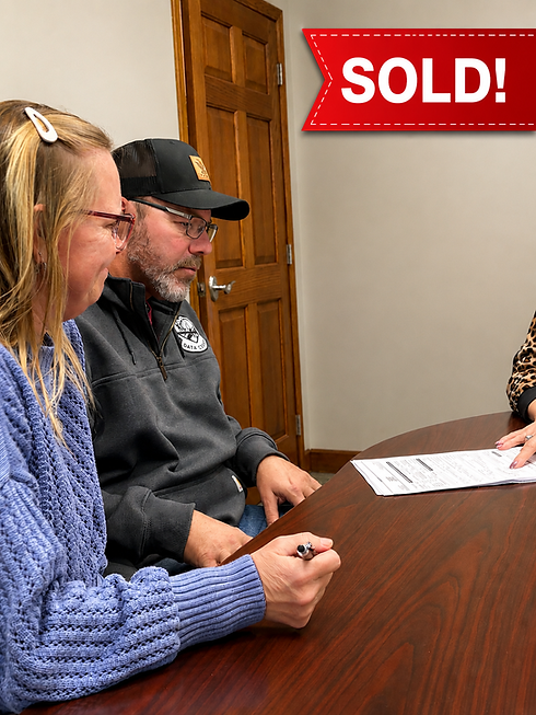 Clients signing for house they purchased.png