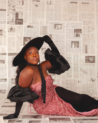 Creative photoshoot in front of newspaper wall at the New Wine Photo Studio in Mesquite, Texas