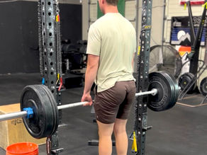 A man lifting weights with barbell in a gym