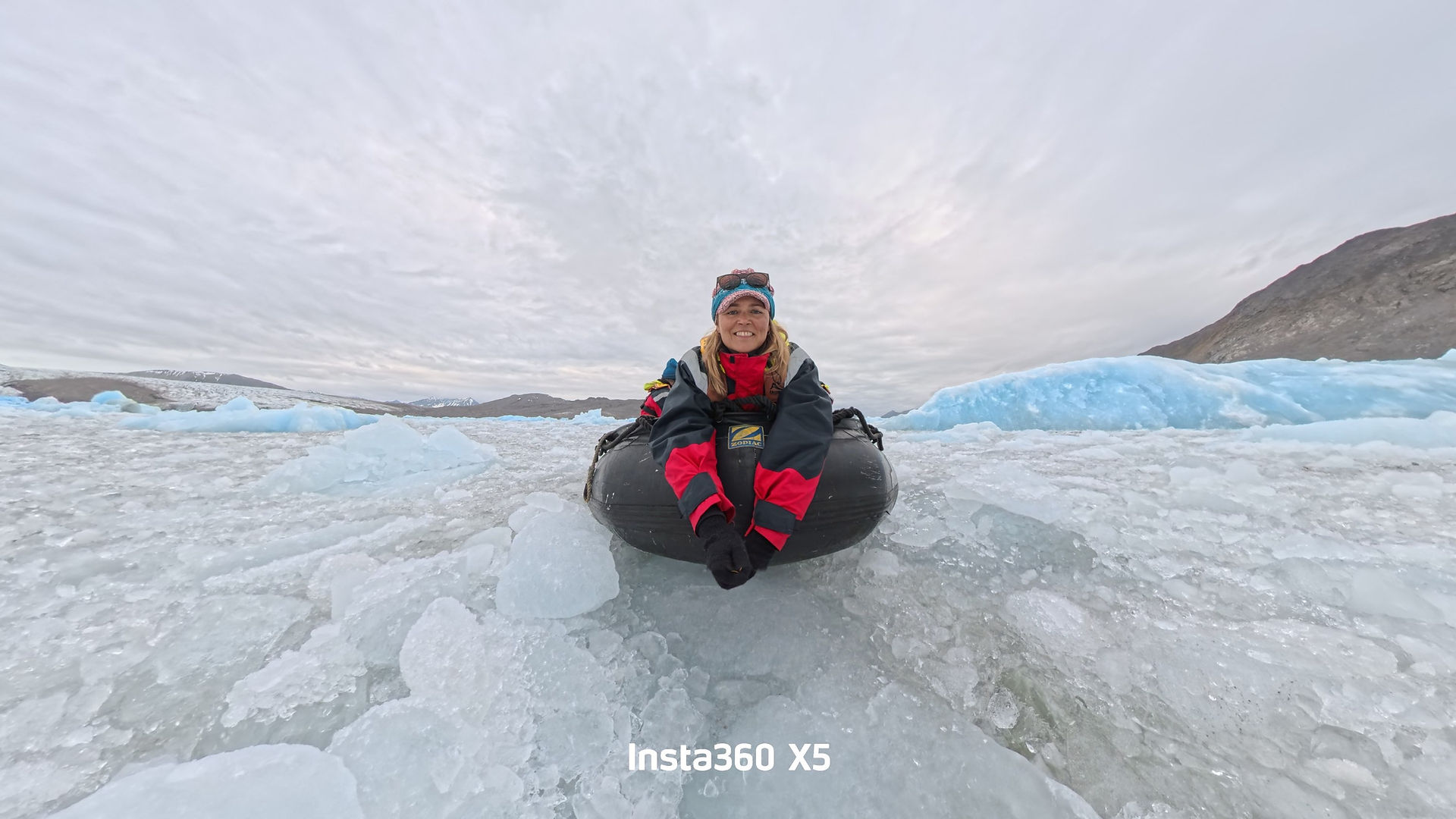 Woman on the front of an inflatable boat in ice flows