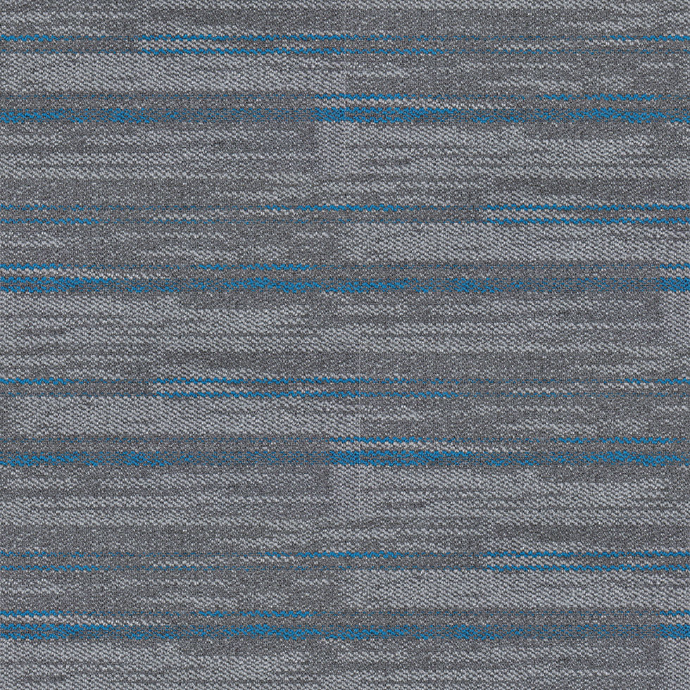 Modern office flooring installation featuring carpet tile planks in a dynamic 90-degree herringbone zig-zag pattern.