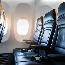 Photograph of airplane seats. Links to Travel page.