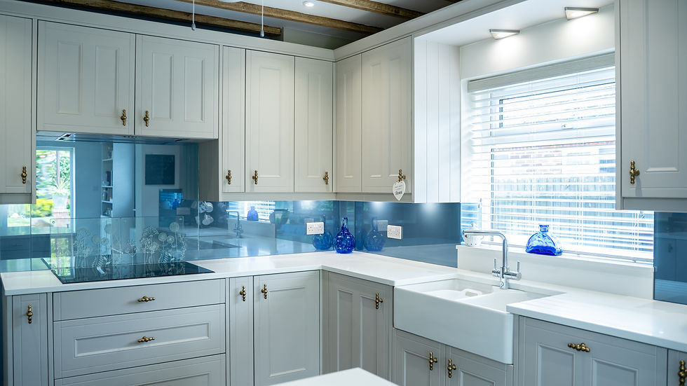 White kitchen with blue glass splashback