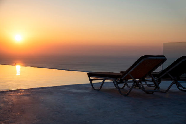 Eagle Mountain & Beach Villa overlooking the ocean at suunset