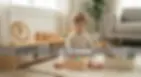 2-year-old British child solving a wooden shape sorting puzzle.