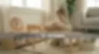 4-6 year old child working on a complex 3D wooden logic puzzle at a table.