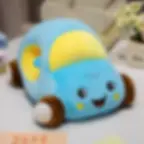 A soft sky blue car hand warmer pillow resting on a white desk.