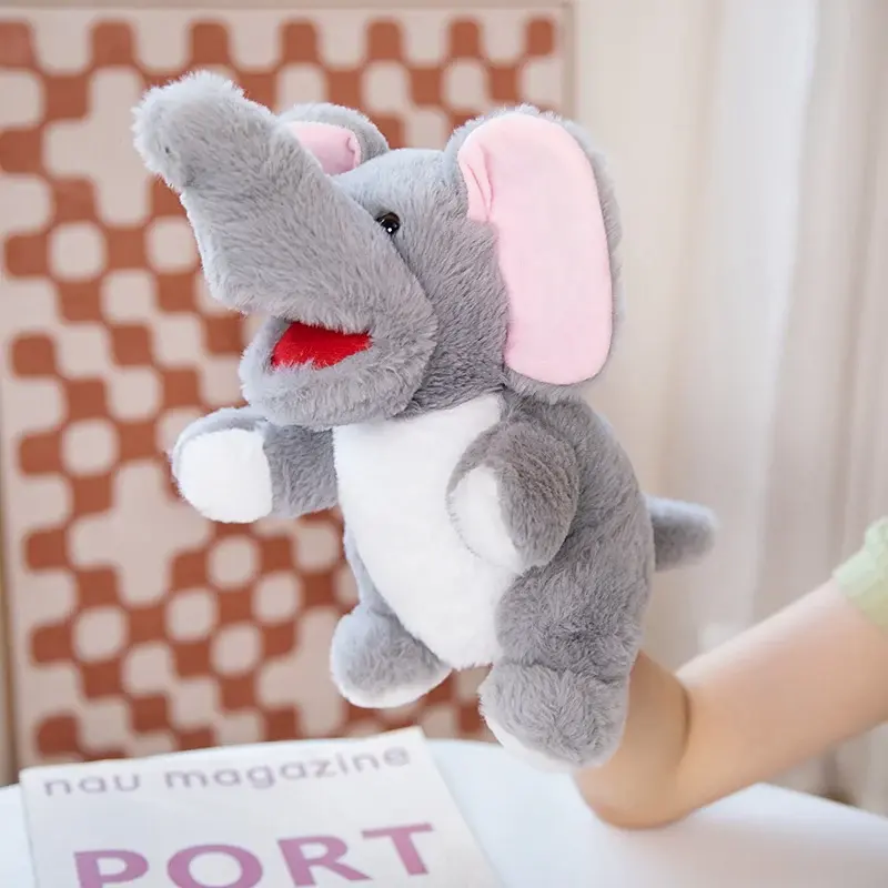 Thumbnail: A grey plush elephant hand puppet featuring a raised trunk and pink inner ears.