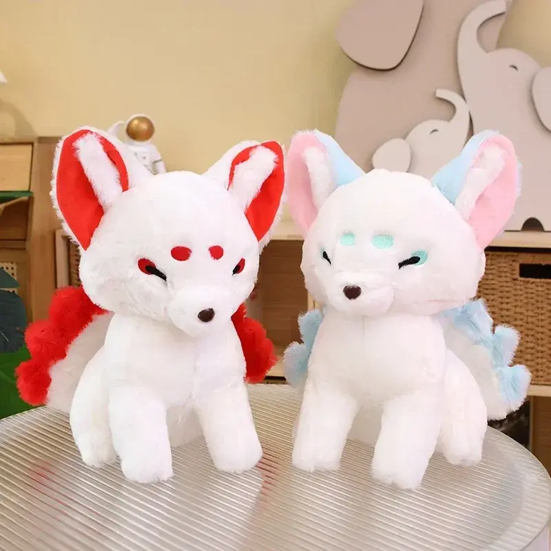 Two chubby white nine-tailed fox plush toys, one with red accents and one with pastel blue accents, sitting side-by-side on a