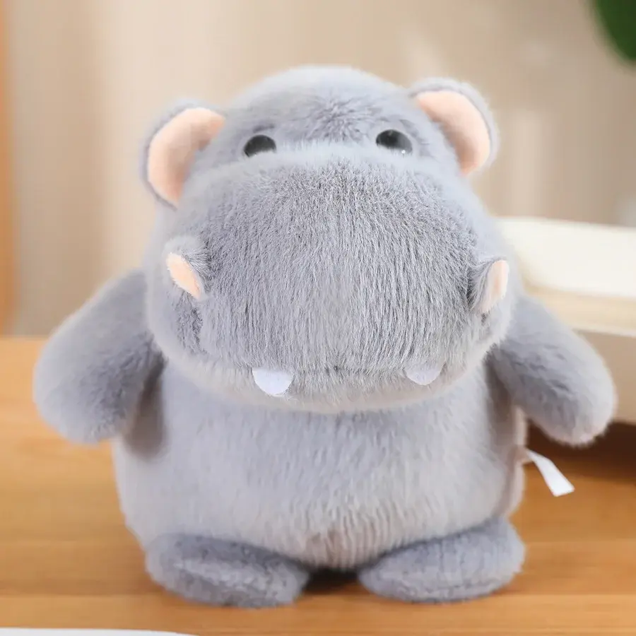 A side-profile shot of a standing gray hippo plushie, highlighting its large snout and chubby, round belly.