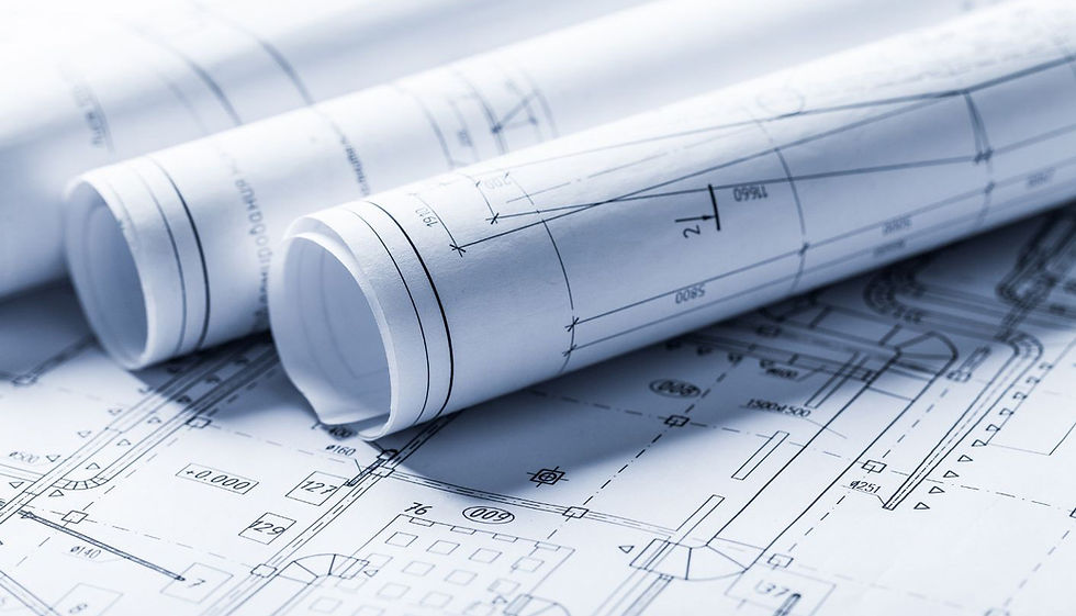 Rolled architectural blueprints showing technical drawings and planning layouts, commonly used for shepherd’s hut UK planning applications.