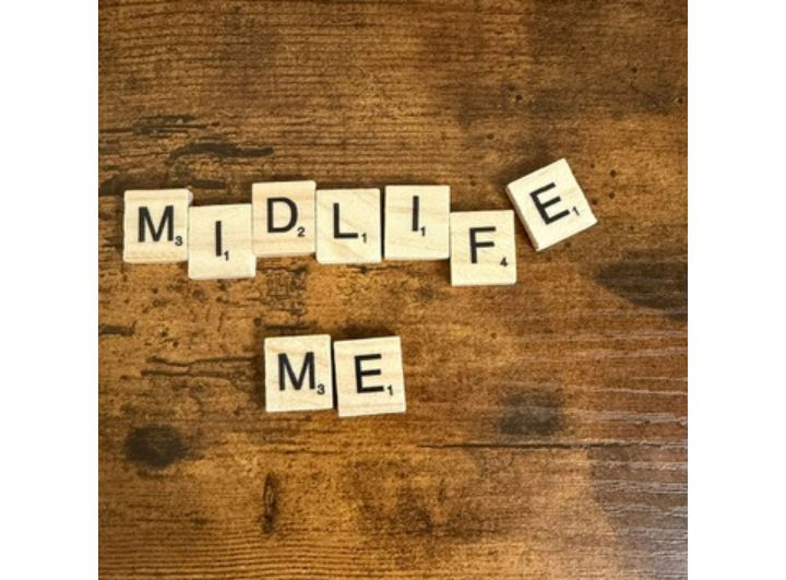 'Midlife Me' written in tiles on a wood background