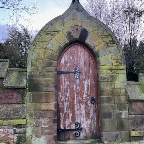 Closed wooden door in stone archway