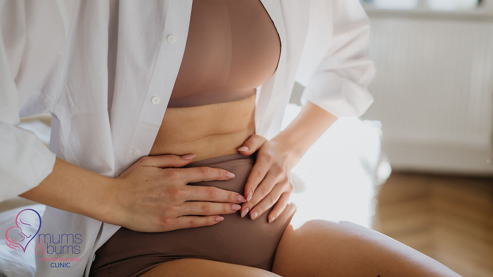 Woman in postpartum underwear holding her abdomen.