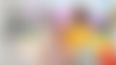 Two women with a rainbow flag promoting inclusive pap smear screening for everyone with a cervix.